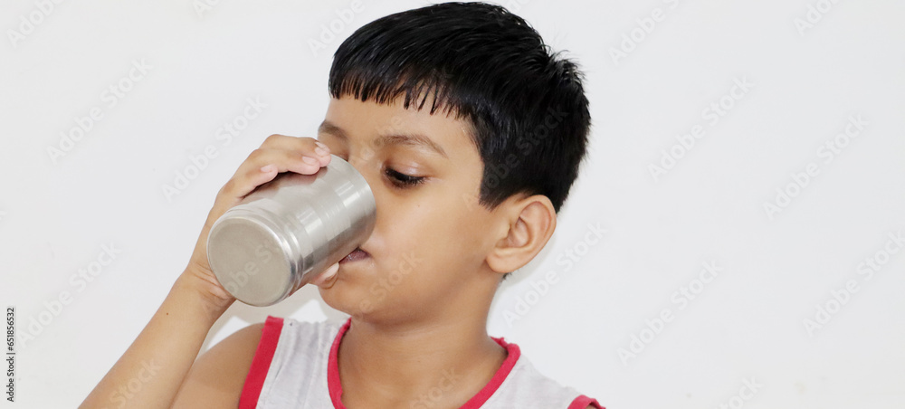 little boy drinking water from glass with copy space little boy drinking water from glass with copy space