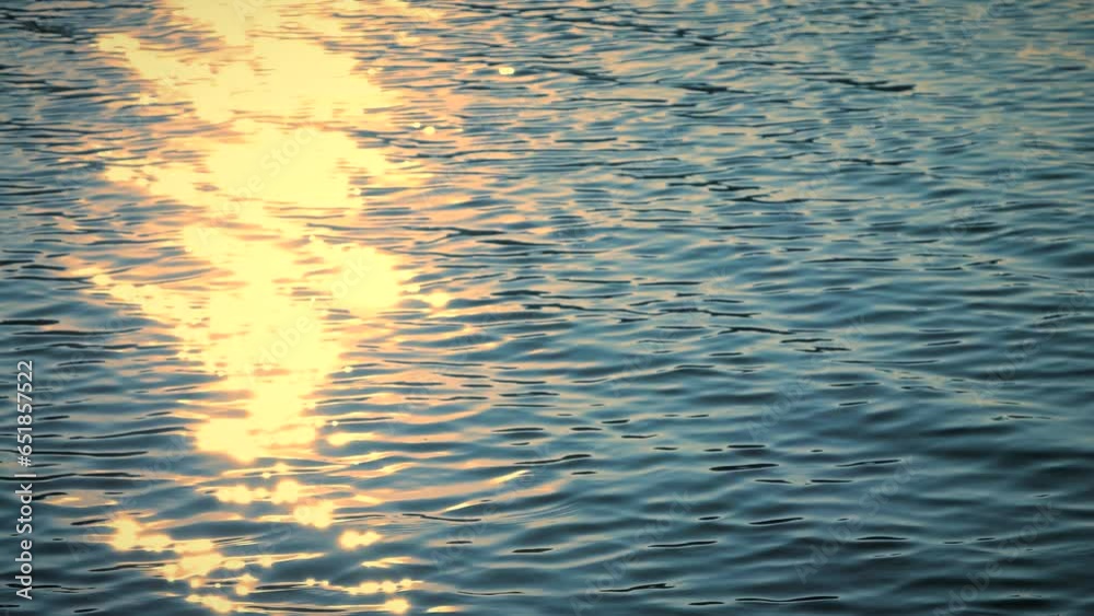 Beautiful reflection yellow sunset light on blue water, rippled waves, calm natural crystal clean fresh water, effect, scene, sea, wet, wavy, pool, sun, shine, slow motion, close up, hd. ProRes 422 HQ Beautiful reflection yellow sunset light on blue water, rippled waves, calm natural crystal clean fresh water, effect, scene, sea, wet, wavy, pool, sun, shine, slow motion, close up, hd. ProRes 422 HQ