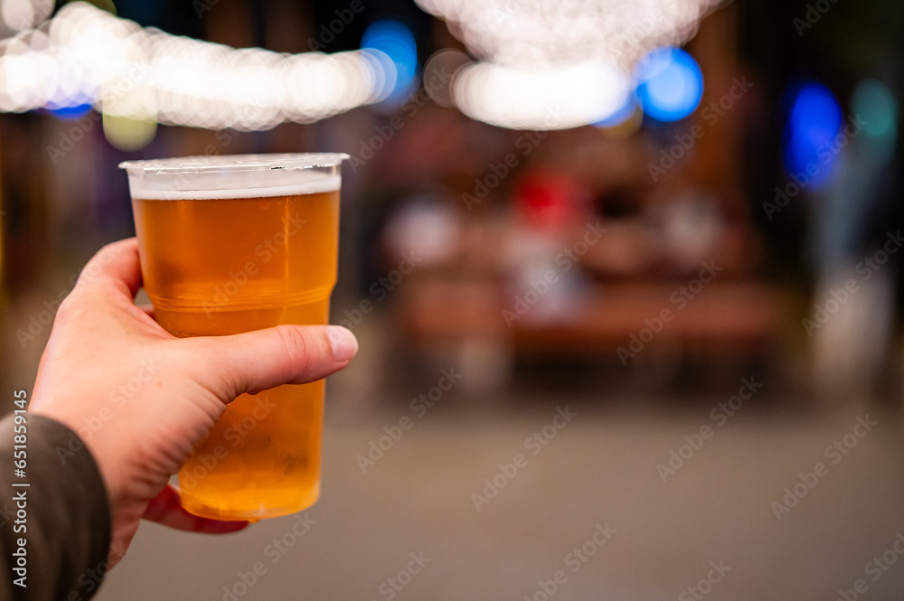 plastic cup glass with beer in hand. Outdoor summer festival plastic cup glass with beer in hand. Outdoor summer festival