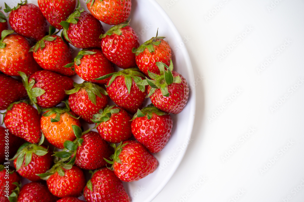 Fresh strawberries just picked from the tree on a white background