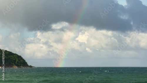 Thailand Phuket Andaman Sea 01.09.2023: Rainbow Ocean waves and clouds photo