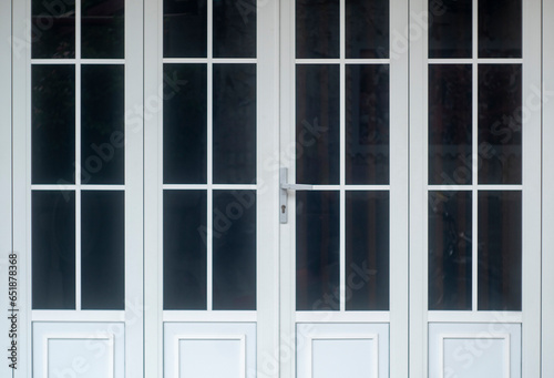 Close up view of steel door handles on glass doors isolated