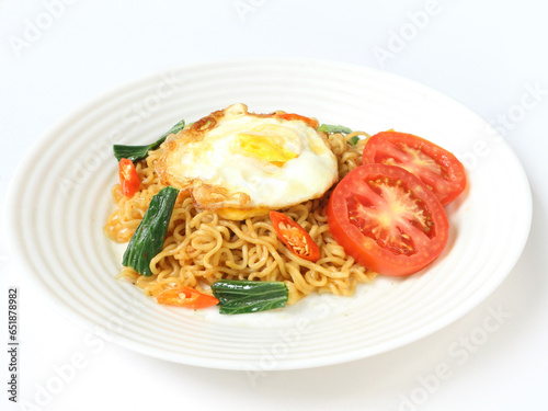 Fried instant noodles are served on a plate with a white background