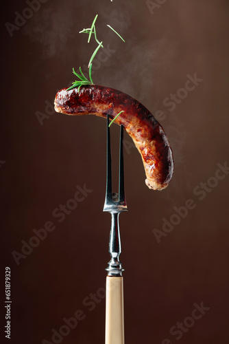 Grilled Bavarian sausage with rosemary.