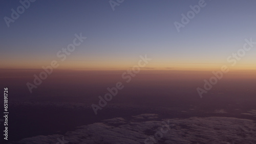 Airplane shot of flying over clouds in sunset © GCapture