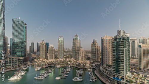 Panorama showing Dubai marina tallest skyscrapers and yachts in harbor aerial. © neiezhmakov