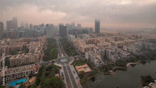 Skyscrapers in Barsha Heights district and low rise buildings in Greens district aerial night to day.