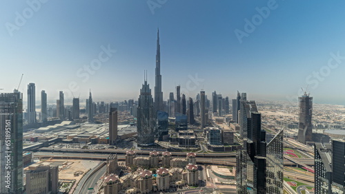 Panorama showing aerial view of tallest towers in Dubai Downtown skyline and highway.