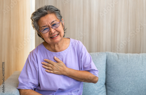 Senior asian adult elderly woman with chest pain suffering from heart attack, health and medical, heart health, heart attack, world heart day, cardiovascular disease.insurance and hospital concept.