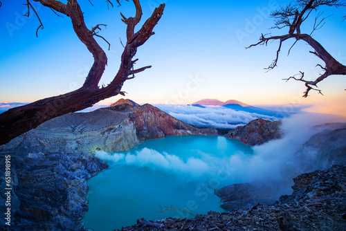 Amazing of Mountains rock cliff at Kawah Ijen volcano with turquoise sulfur water lake at sunrise.Amazing nature landscape view at East Java, Indonesia. Natural landscape background