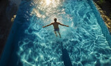 Top view of man swimming in pool. Background for sport and recreation on holiday.