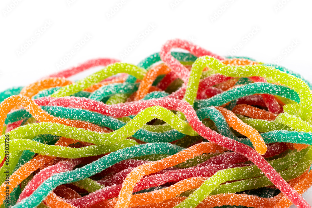Multicolored jelly candies in the shape of the spaghetti sprinkled with sugar. Close up