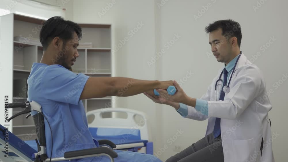 A Man do exercises with elastic band, Physiotherapy Program, Healthcare Concept Doctor helping patient in wheelchair with dumbbells doing rehabilitation exercise in medical center A Man do exercises with elastic band, Physiotherapy Program, Healthcare Concept Doctor helping patient in wheelchair with dumbbells doing rehabilitation exercise in medical center