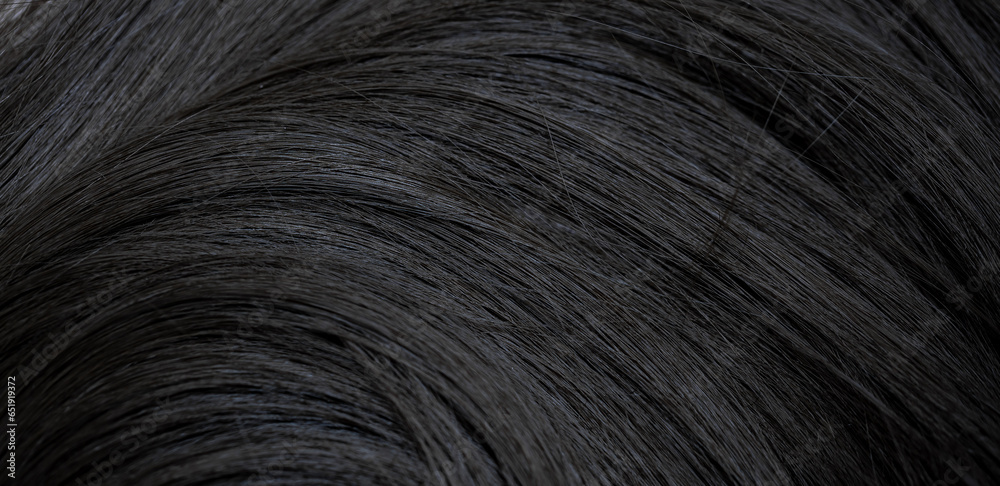 Brunette or black hair. Female long dark hair in black. Beautifully laid curls. Closeup texture in a dark key. Hairdressing, hair care and coloring. Shading gray hair. Background with copy space. - obrazy, fototapety, plakaty 
