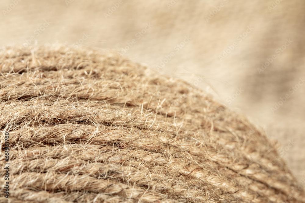A ball of coarse textured jute threads on a burlap napkin A ball of coarse textured jute threads on a burlap napkin