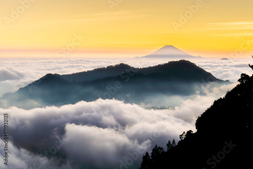 View of the sea of ​​clouds at sunset and several mountains on the Dieng plateau, Central Java, Indonesia photo