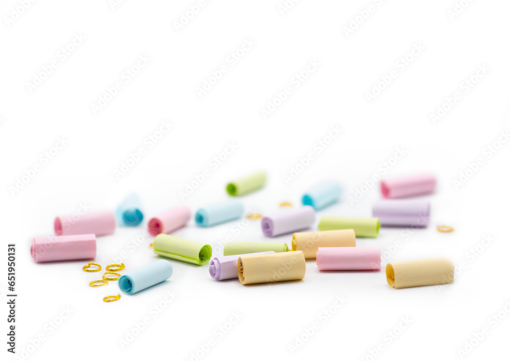 Colorful paper note with gold rings isolated on white background. A way to send special message to someone. spot focus and copy space Colorful paper note with gold rings isolated on white background. A way to send special message to someone. spot focus and copy space