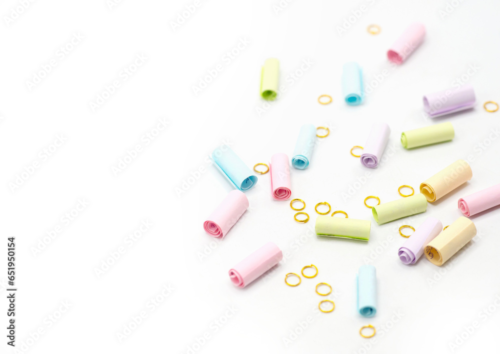 Colorful paper note with gold rings isolated on white background. A way to send special message to someone. spot focus and copy space Colorful paper note with gold rings isolated on white background. A way to send special message to someone. spot focus and copy space