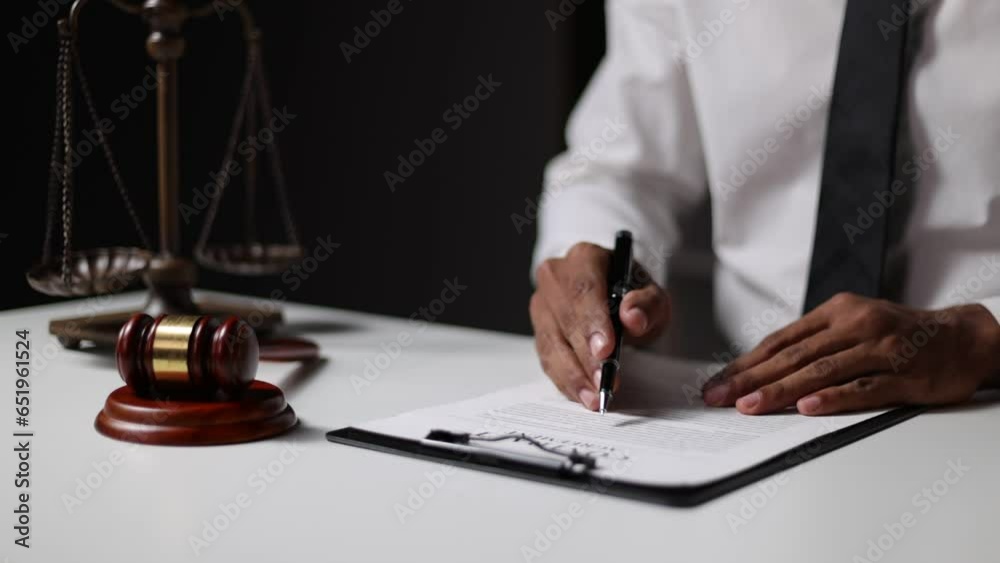 Judgment and legal justice concept, auction, The lawyer reads the document and signs the decision. Judgment and legal justice concept, auction, The lawyer reads the document and signs the decision.
