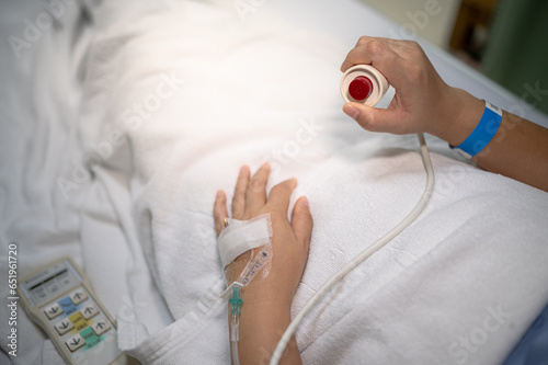 фотографія Patient press red emergency button to calling nurse for help in hospital