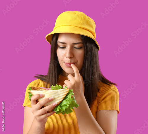Young woman eating tasty sa...