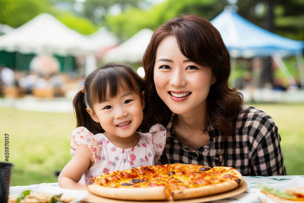 Young mother enjoying pizza slice at park isolated on a white background 