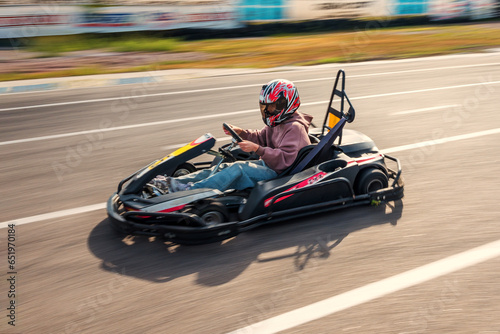 Girl racer driving a go-kart on a race track © Родион Бондаренко