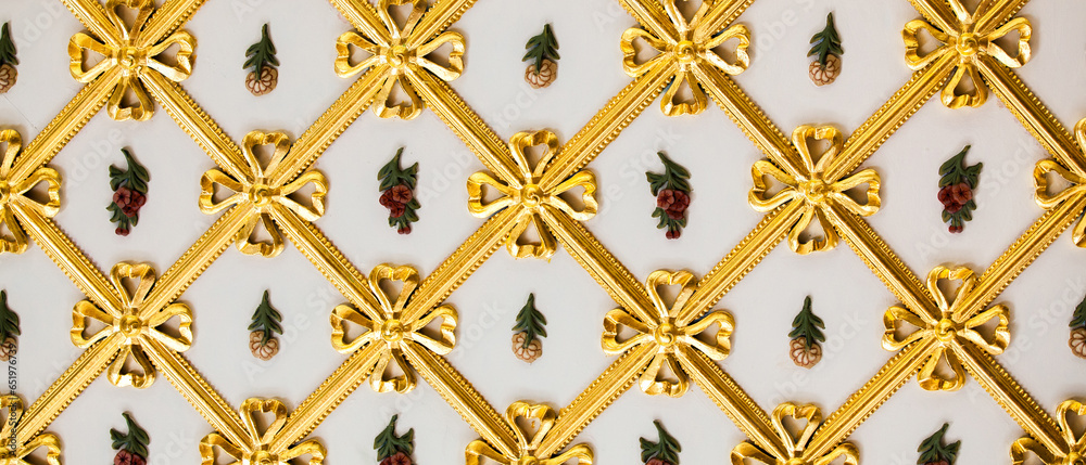 Vintage gold wall ornaments around flowers texture 