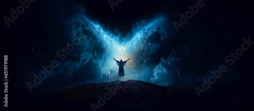 Angel, the messenger of God. Man spreading his arms under wings with a night sky background