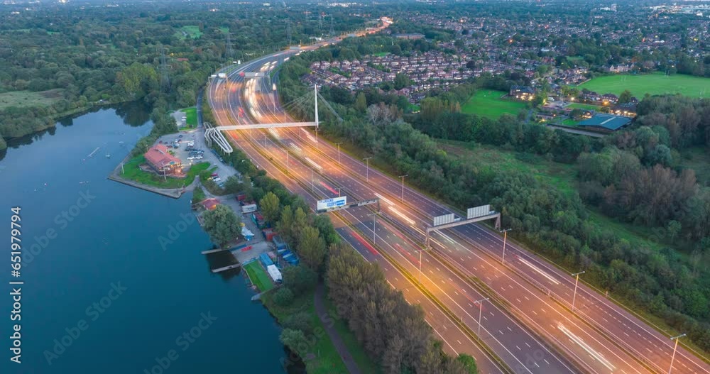 Aerial hyper lapse video of traffic flowing on M60, Sale Water Park, Greater Manchester. 