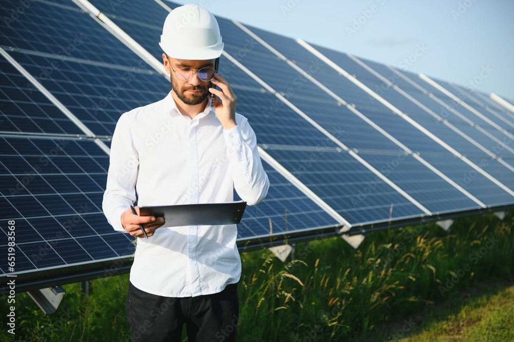 Solar power plant. Engineer on a background of photovoltaic panels. Science solar energy Solar power plant. Engineer on a background of photovoltaic panels. Science solar energy