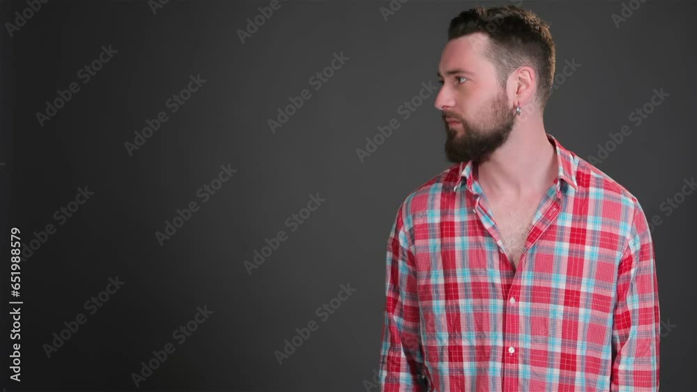 Bearded man keeps his hand in pockets Bearded man keeps his hand in pockets