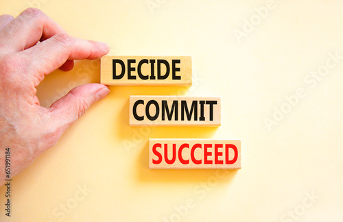 Decide commit succeed symbol. Concept word Decide Commit Succeed on beautiful wooden block. Businessman hand. Beautiful white table background. Business decide commit succeed concept. Copy space. photo