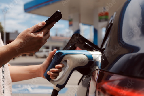 EV charging station for electric car in concept of green energy and eco power produced from sustainable source to supply to charger station in order to reduce CO2 emission .