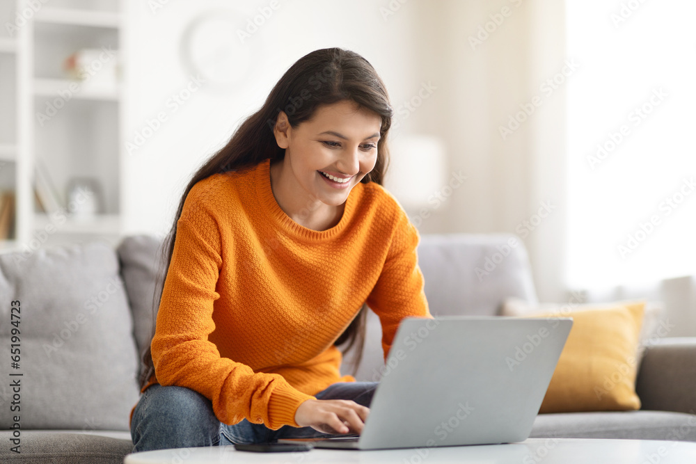 Happy young indian woman freelancer working from home, copy space Happy young indian woman freelancer working from home, copy space