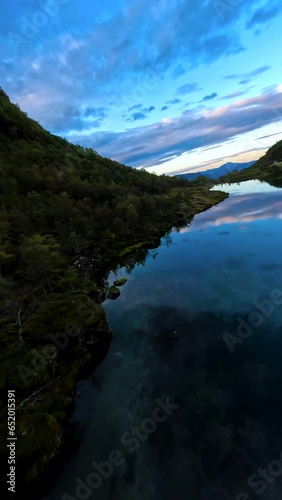 Flying over a lake reflecting a colourful sunset