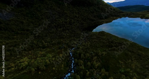 Flying over a lake reflecting a colourful sunset