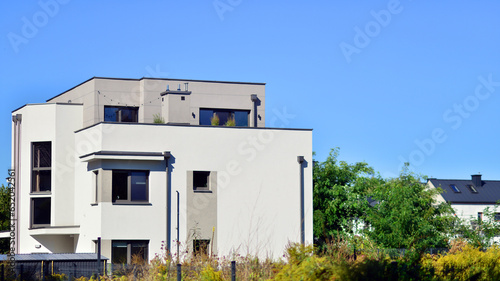 Luxury real estate single family house with modern facade. View during sunny day.