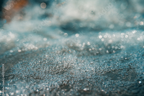Abstract water in mountain river with water bubbles, close-up view