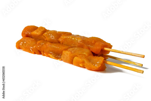 Moorish chicken pinchitos, raw chicken skewer, isolated on white background. In Andalusia, “pinchitos” are one of the most typical tapas in many bars. Spanish food concept. photo