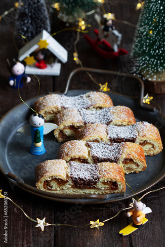 Grandfather's mustache cookies made from shortcrust pastry filled with nuts, jam and cocoa, Christmas toys and garland.