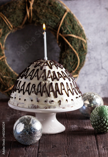 Pancho cake made of chocolate biscuit with sour cream and pineapple in New Year's or Christmas decoration. Rustic style.