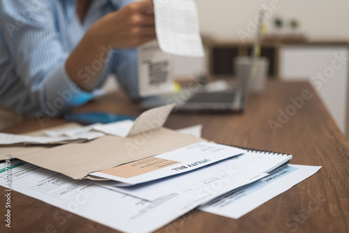 Quadro su tela Utility bills with total amount for online payment through laptop lie on table w