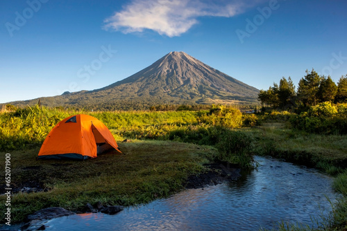 orange tent on the mountain.  Camping on Mount Semeru, Indonesia.  hikking activity. © Andri