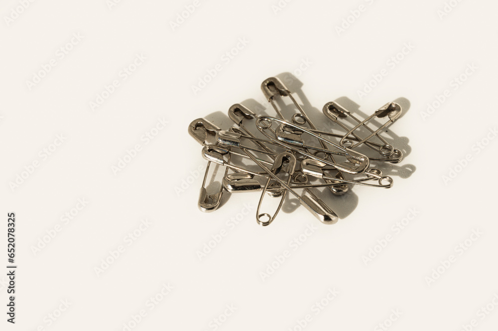 closed safety pins on a white background closed safety pins on a white background