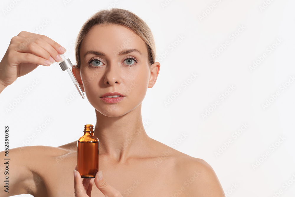 Beautiful woman with cosmetic serum in her hands on white background, space for text Beautiful woman with cosmetic serum in her hands on white background, space for text