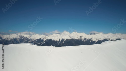 Aerial view active people ski tour alpine hikers tourists walking skitour trail snowy mountain slope. Extreme adventure winter sport outdoors. Panoramic nature landscape trekking skiers backpacking 2 photo