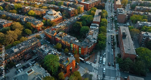 Low-rise multistoried buildings of residential area in Boston, USA. Lots of cars are on the city streets. Top view. photo