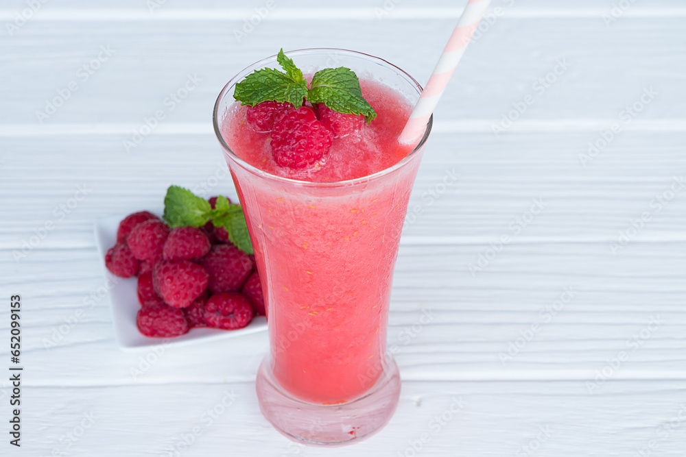 Raspberry smoothie red colorful fruit juice milkshake blend beverage healthy high protein the taste yummy In glass drink episode morning on white wood background. Raspberry smoothie red colorful fruit juice milkshake blend beverage healthy high protein the taste yummy In glass drink episode morning on white wood background.