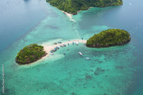 Aerial view of boats with clear blue separated island, turquoise seawater, Andaman sea in Phuket island in summer season, Thailand. Water in ocean material pattern texture wallpaper background.